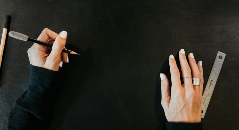 Designer sketching a logo with pencil and ruler