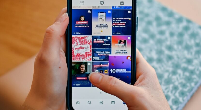 Hands holding a phone showing a social media feed